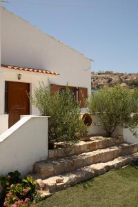 a house with stairs leading up to a door at Villa Aelia Kefalos-Private & Spacious with Pool in Kámpos