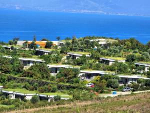 an aerial view of houses on a hill next to the ocean at SunkissedVilla in Draç