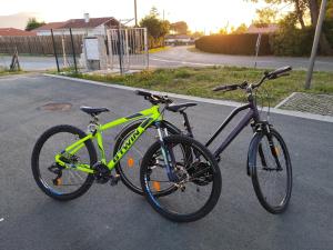 two bikes parked next to each other on a street at Chez Mika in Linxe