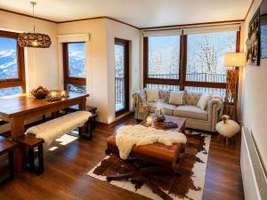 a living room with a couch and a table at Departamentos Exclusivos Termas de Chillán in Nevados de Chillan +128 photos