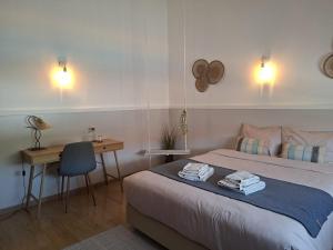 a bedroom with a bed and a desk and a desk at Vila Glória Guesthouse in Lagos +44 photos