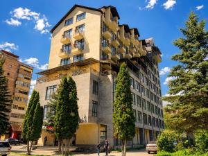 a tall building with a tree at Riverside Penthouse in Dilijan in Dilijan