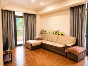 a living room with a couch in front of a window at Riverside Penthouse in Dilijan in Dilijan