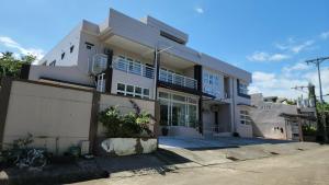 a large white building with a lot of windows at Domus Florum Travellers Inn in Legazpi