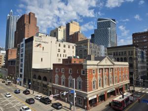 a city with buildings and cars on a street at Stay Pittsburgh in Pittsburgh