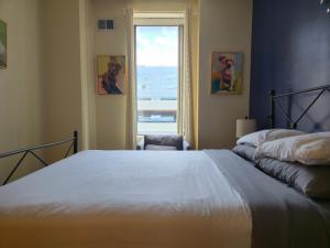 a bedroom with a large bed and a window at Stay Pittsburgh in Pittsburgh