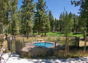 a fence around a swimming pool in a yard at Cabins 13 in Old Mammoth