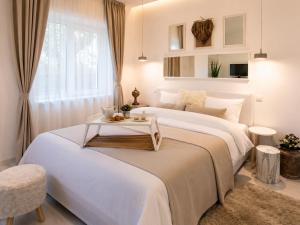 a bedroom with a large bed with a table on it at Metropole Apartments Romana Square in Bucharest