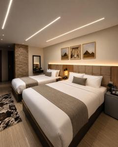 a hotel room with two beds in a room at Crowne Pyramids View inn in Cairo