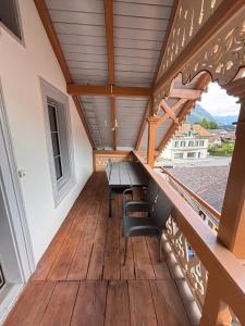 a balcony of a house with a table and chairs at Villa Epoka in Interlaken