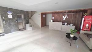 a lobby with a couch and a counter in a building at Apartamento EL PRADO de lujo in Cochabamba