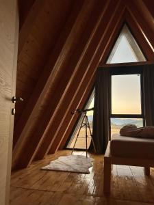 a bedroom with a window with a tripod next to a bed at Piva Paradise in Plužine