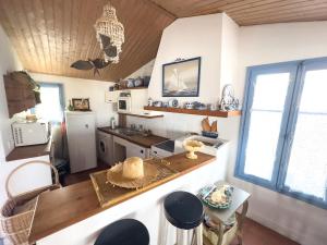 a kitchen with a sink and a counter top at Charmante maison front de mer avec jardin in La Guérinière