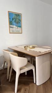 a dining room table with white chairs and a table at Mar'al Mar Luxury Escape in Himare +5 photos