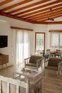 a living room with a couch and a table at Villa Aelia Kefalos-Private & Spacious with Pool in Kámpos