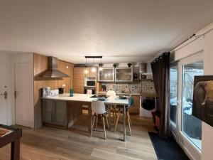 a kitchen with a table and chairs in a room at Disney Harmony Flat in Saint-Thibault-des-Vignes