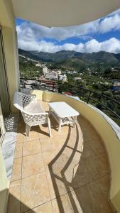 a balcony with a table and a bench on a balcony at Mar'al Mar Luxury Escape in Himare
