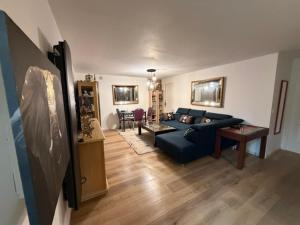 a living room with a blue couch and a table at Disney Harmony Flat in Saint-Thibault-des-Vignes