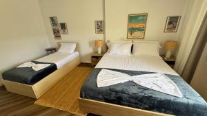 two beds in a small room with a bow tie on them at Mar'al Mar Luxury Escape in Himare