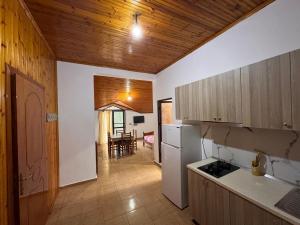 a kitchen with a refrigerator and a dining room at Hotel Gjinaj in Shëngjin +20 photos