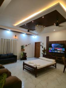 a living room with a couch and a table at Dsouza Stay in Mysore