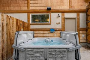 a jacuzzi tub in the middle of a building at Pinedale Cabin in McCall