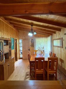 a kitchen and dining room with a table and chairs at Parcela Peumayen casa 1 in Coñaripe +12 photos