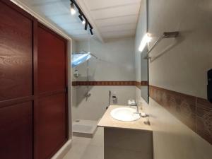a bathroom with a sink and a shower at HYN Mountain Resort in Kohāla