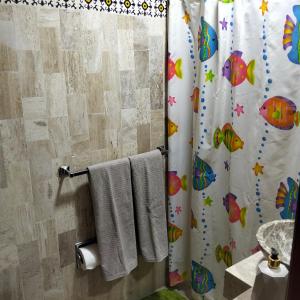 a bathroom with a shower curtain and towels at Villa Cholula in Cholula +34 photos