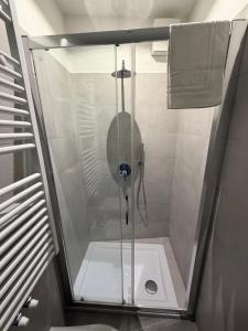 a shower with a glass door in a bathroom at Castle Rhythm in Arco