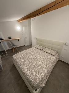 a white bedroom with a bed and a desk at Castle Rhythm in Arco +43 photos