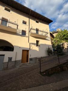 a large white building with a staircase next to it at Castle Rhythm in Arco