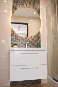 a bathroom with a sink and a mirror at Willa Apart 19A in Karpacz +66 photos