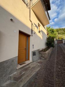 a building with a brown door on the side of it at Castle Rhythm in Arco