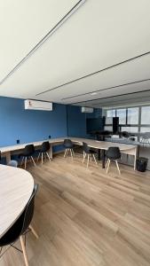 an empty room with tables and chairs in a building at Nomar 208 pe na areia na Praia dos carneiros in Tamandaré +25 photos