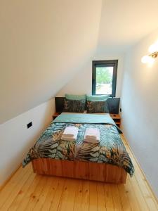 a bedroom with a large bed in a attic at Drina Escape - Lake View in Višegrad