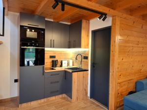 a kitchen with a refrigerator and a sink in a room at Drina Escape - Lake View in Višegrad