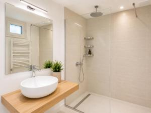 a bathroom with a white sink and a shower at Metropole Apartments Romana Square in Bucharest
