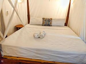 a bed with two pairs of shoes sitting on it at Garden Level Studio in Mtwapa +28 photos