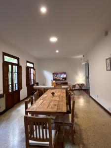 a dining room with a wooden table and chairs at Tranquilidad en Bragado in Bragado