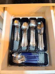 a drawer filled with forks and spoons and utensils at Casa Maestro Tristão in Franca