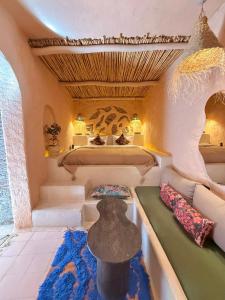 a room with two beds and a couch in it at Casa Amina in Chefchaouen