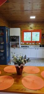 a kitchen with a table with plates on it at Chalé Vale das Montanhas in Timbe do Sul +7 photos