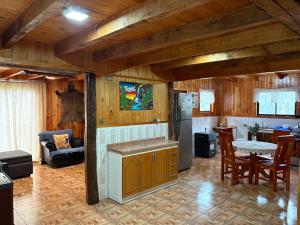 a kitchen and living room with a refrigerator and a table at Parcela Peumayen casa 3 in Pucura