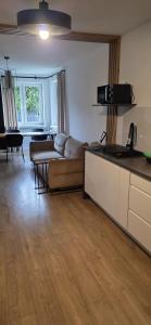 a living room with a couch and a table at Apartament z ogrodem Cyprysowy zakątek in Oświęcim