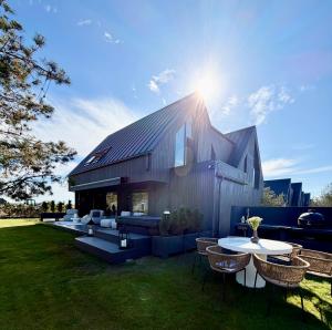 a building with a table and some chairs and tables at VILLA PIKADI BY THE Baltic Sea in Palanga