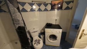 a bathroom with a toilet and a washing machine at Dream Home in Sparta +17 photos