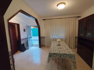a dining room with a table and a view of the ocean at Retiro da Charneca in Fazendas de Almeirim