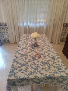 a table with a blue and white table cloth on it at Retiro da Charneca in Fazendas de Almeirim