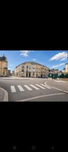 an empty city street with buildings in the background at Appart centre FNAC in Le Mans